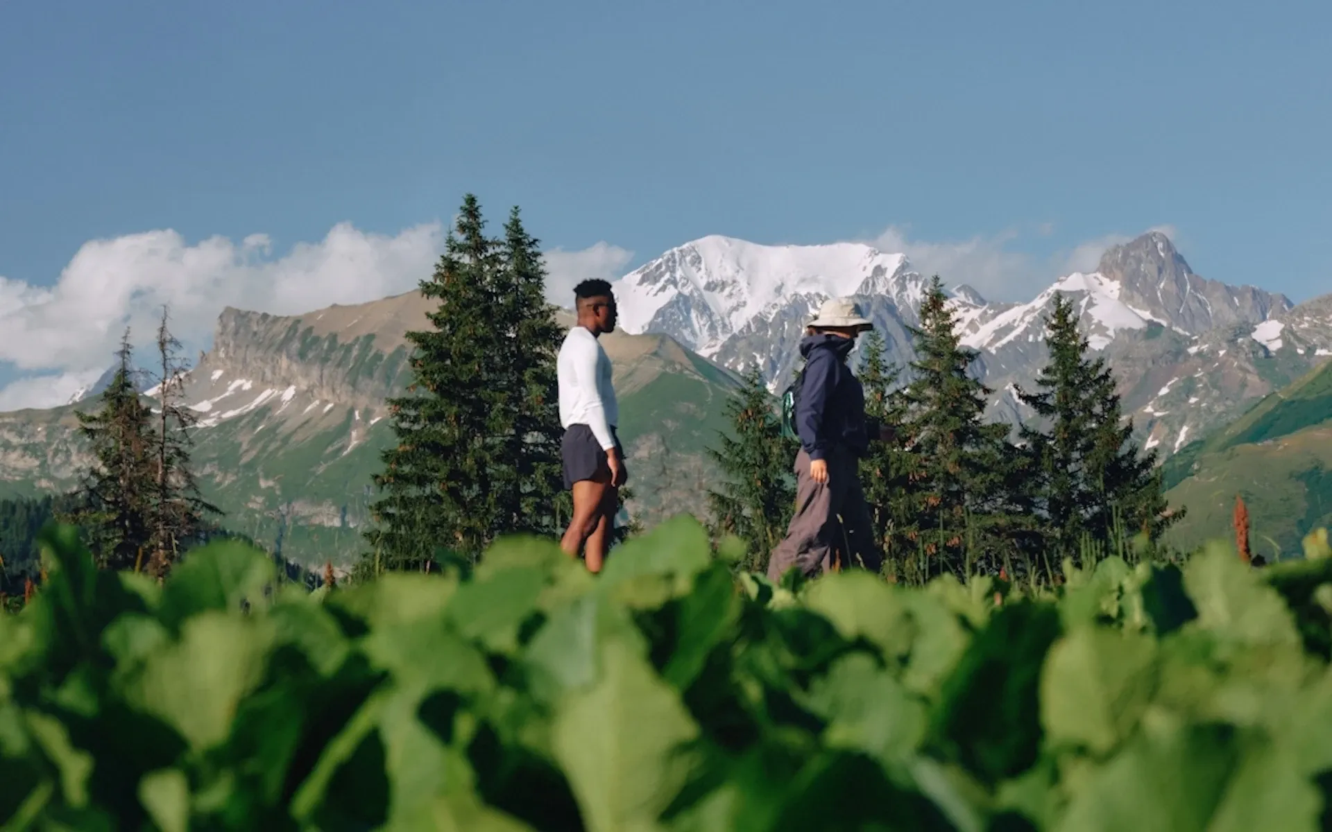 Two people hiking through a field