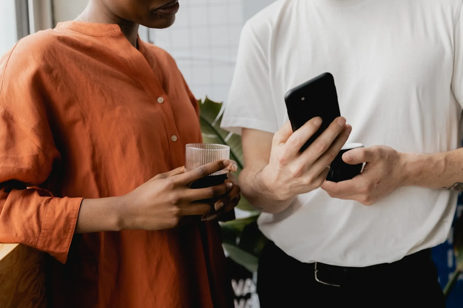 Two people looking at a mobile phone