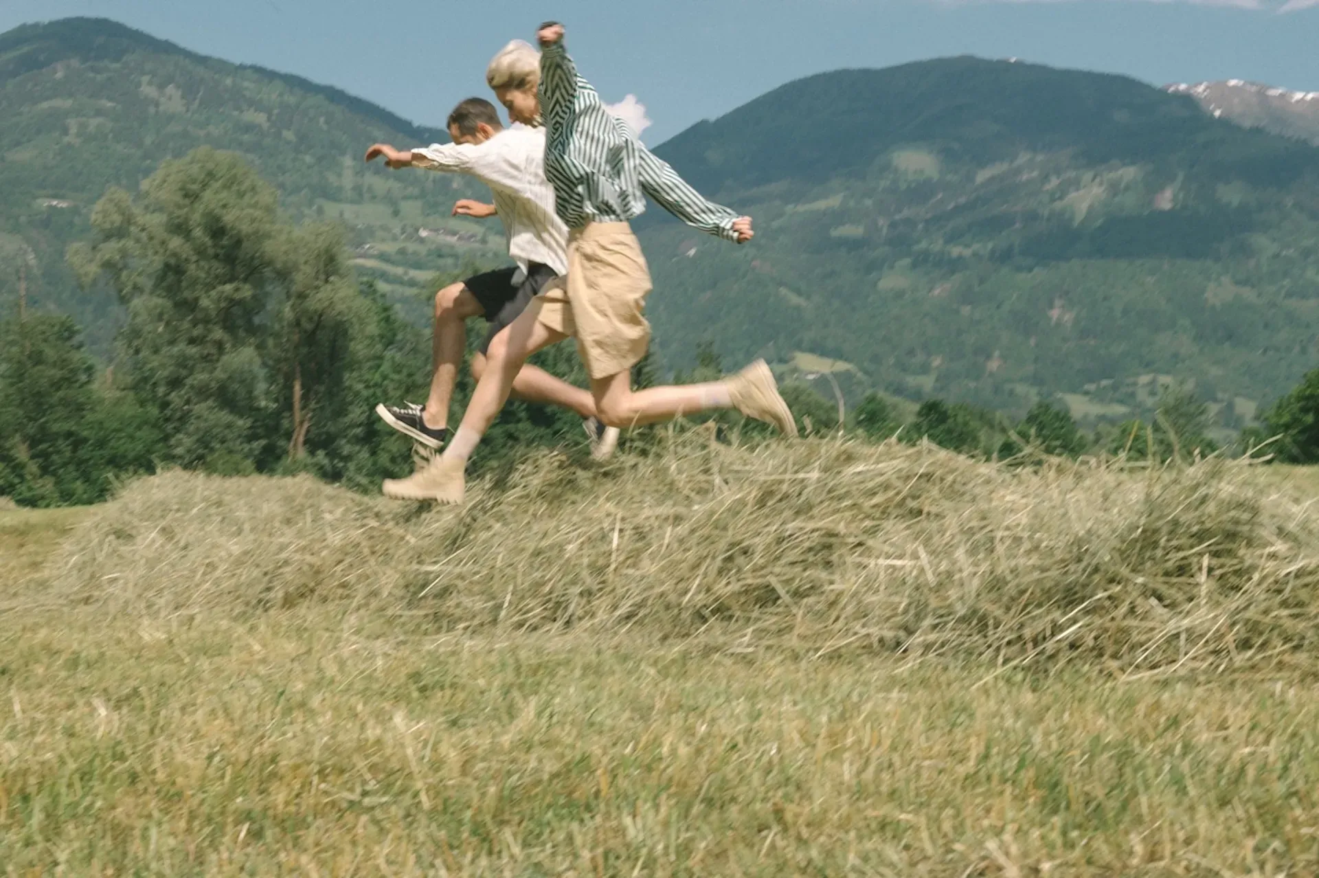 Two people running through a field