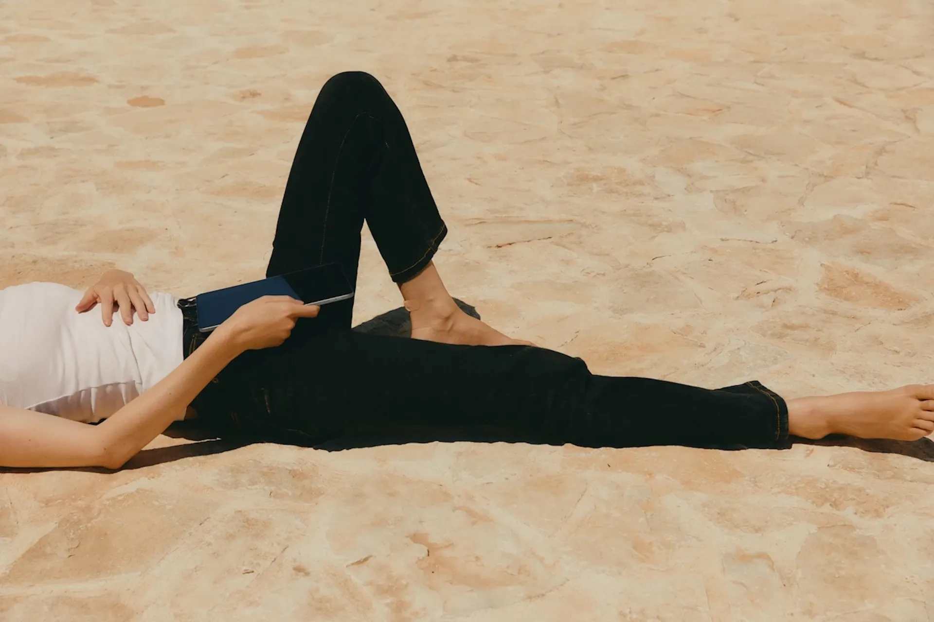 Woman relaxing on the beach with an iPad