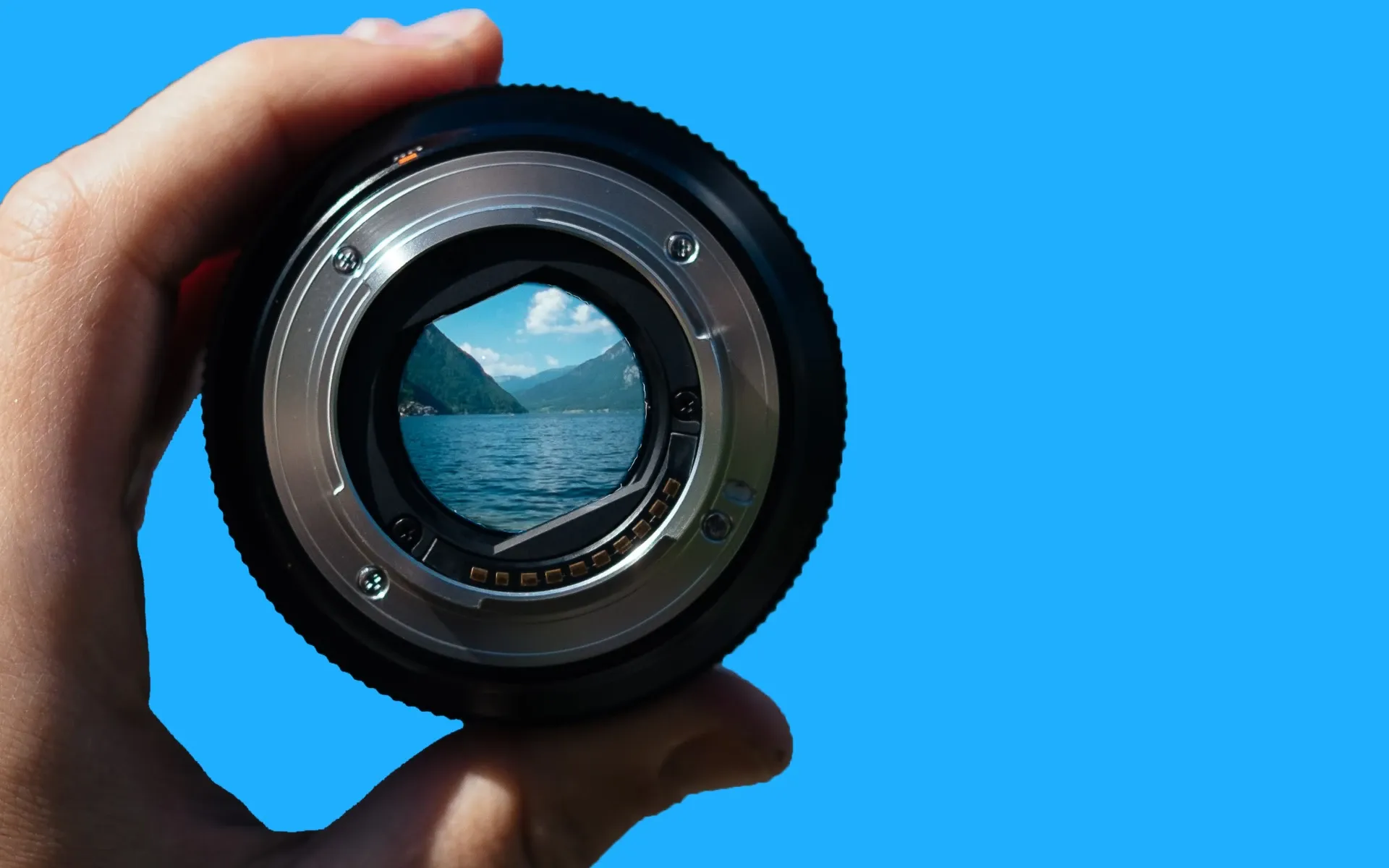 Hand holding a camera lens