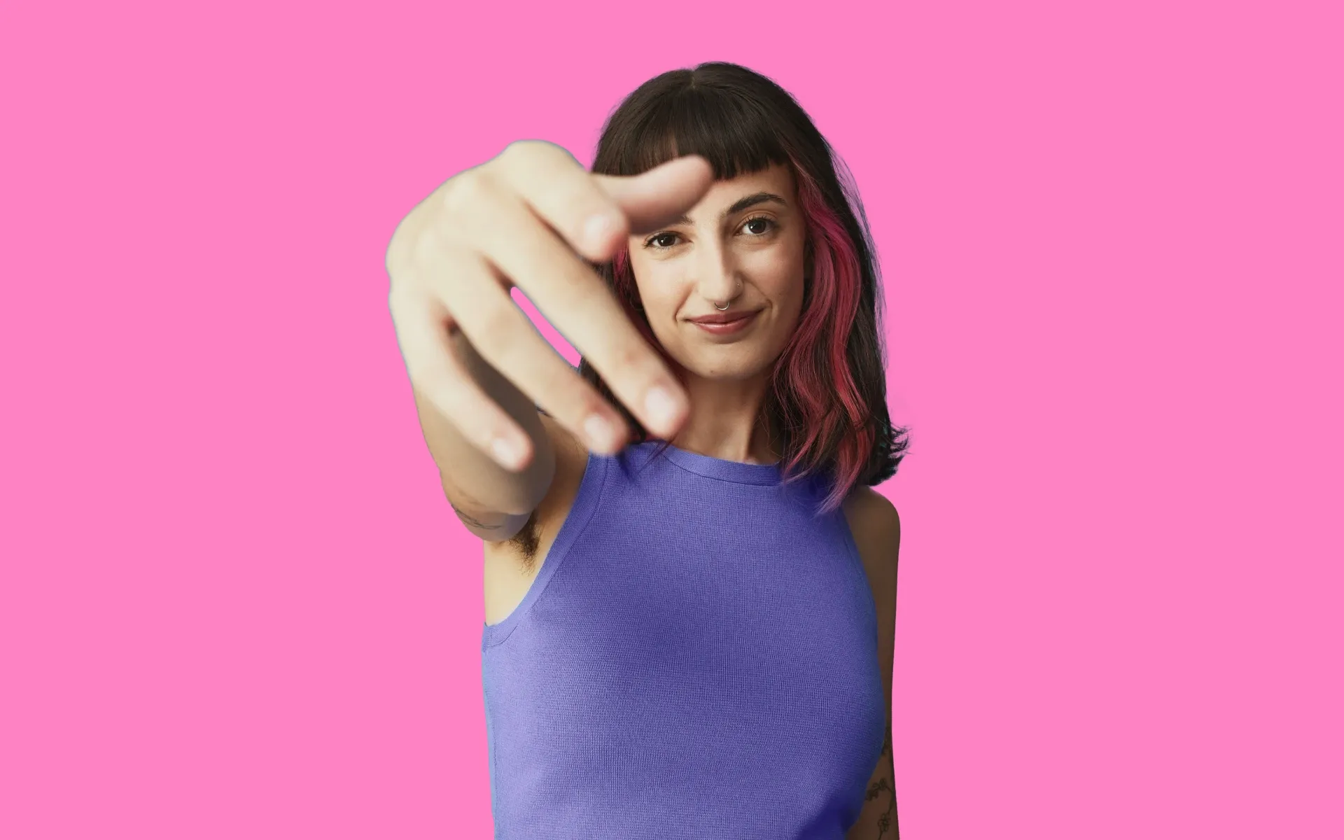 Person with a nose ring and colorful hair