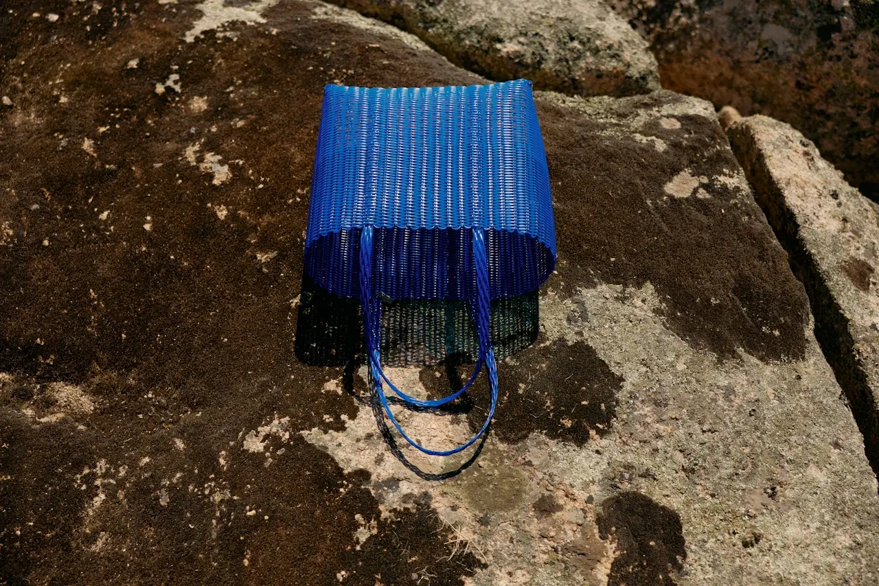 A blue bag sitting on a rock