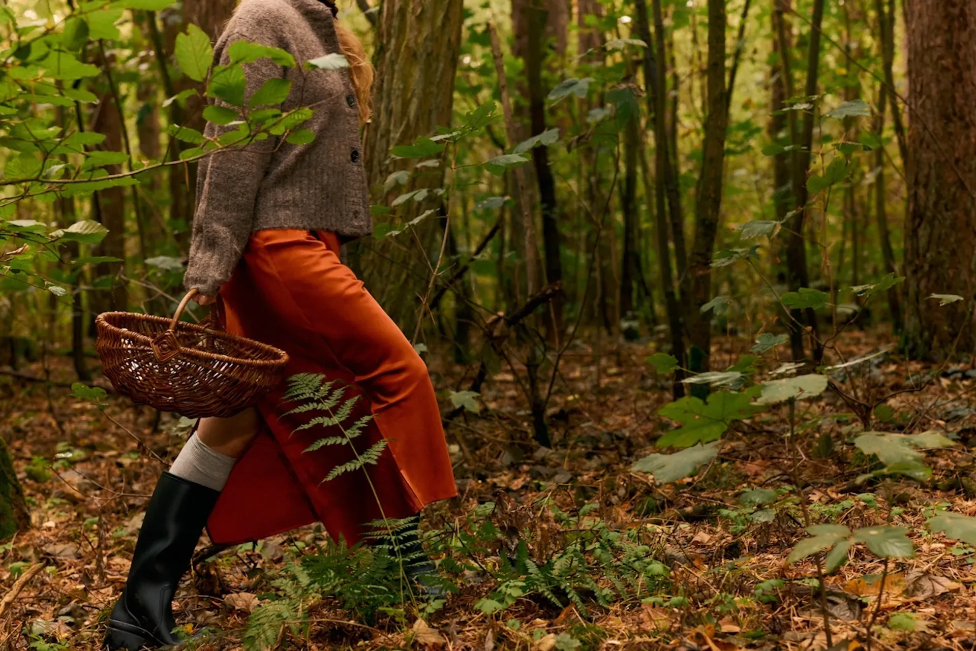 Woman walking through the woods with a basket