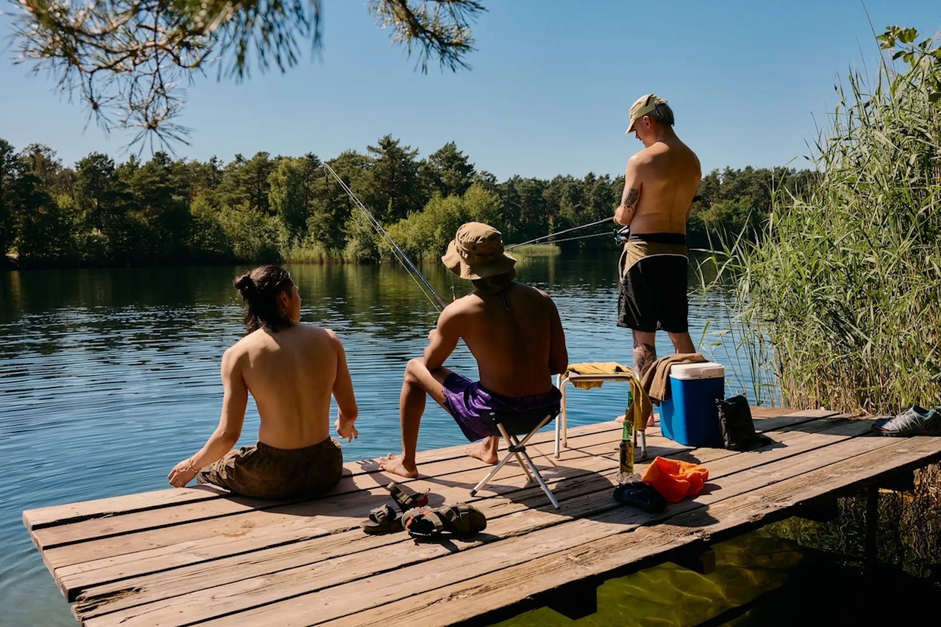 A group of friends hanging out and fishing in the sunshine