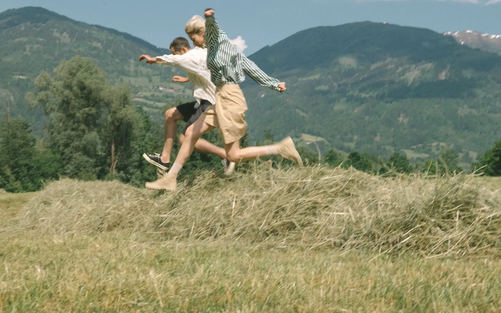 Two friends running in a field