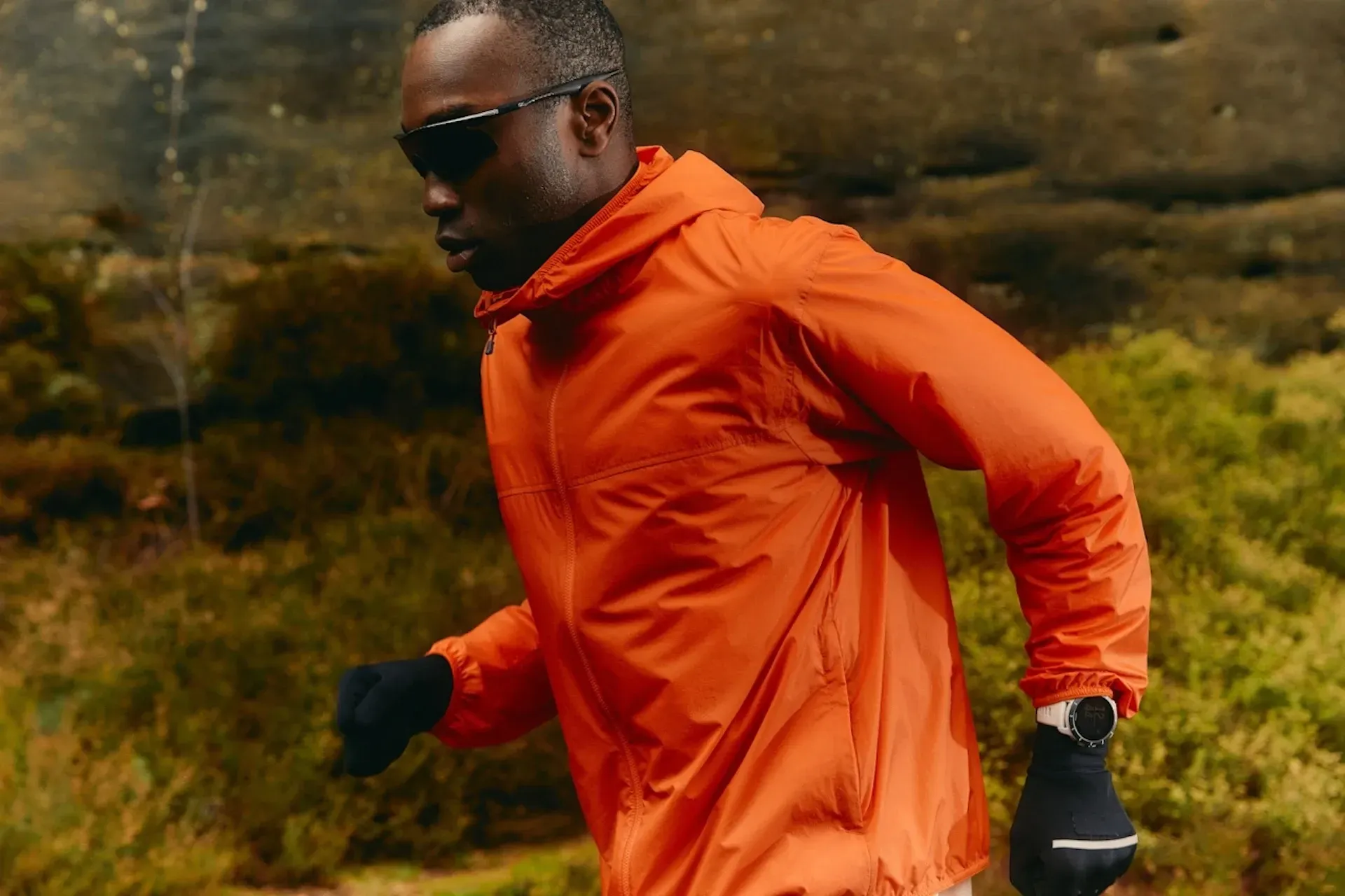 A person in sport gear running through the forest