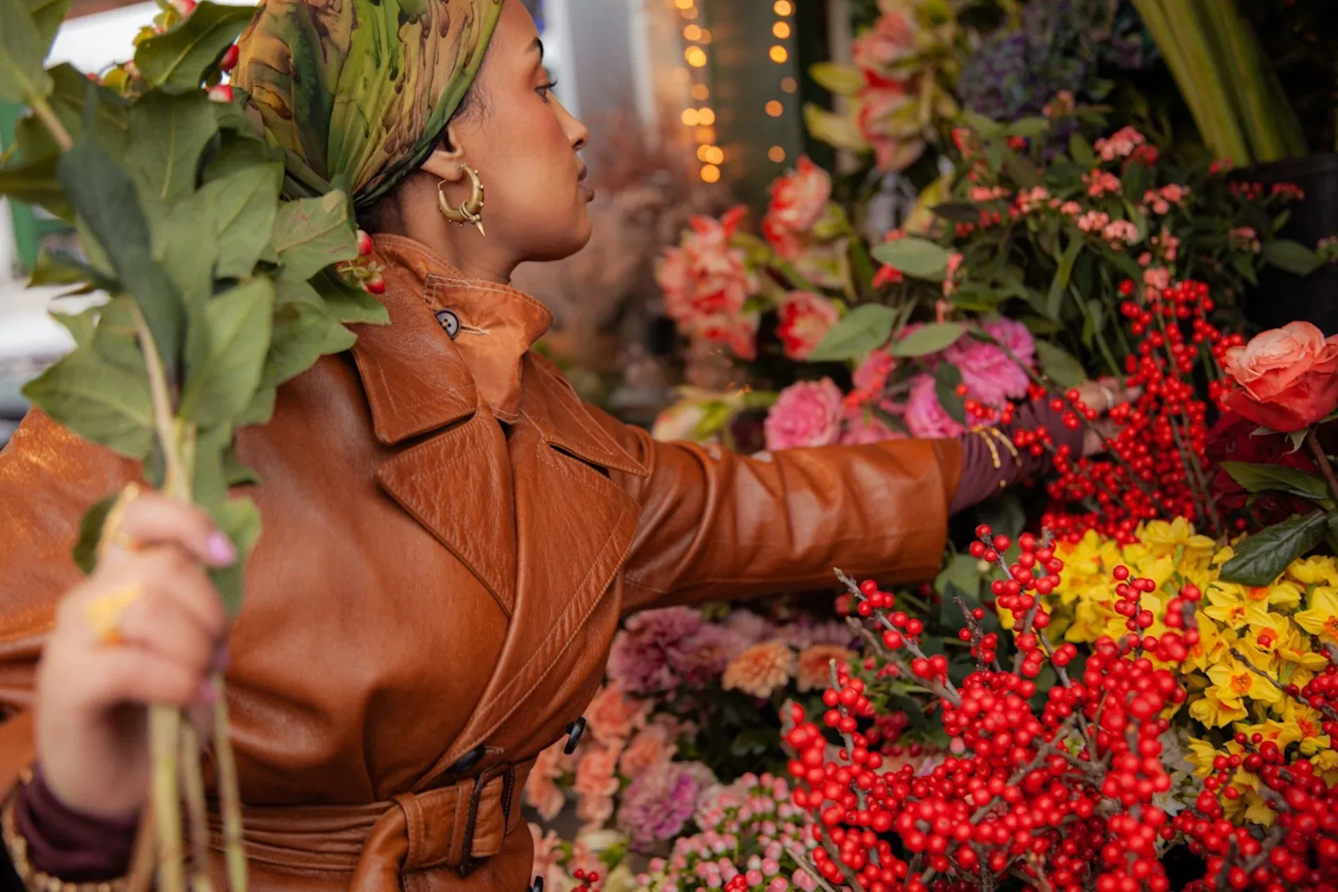 A customer choosing some flowers from a display