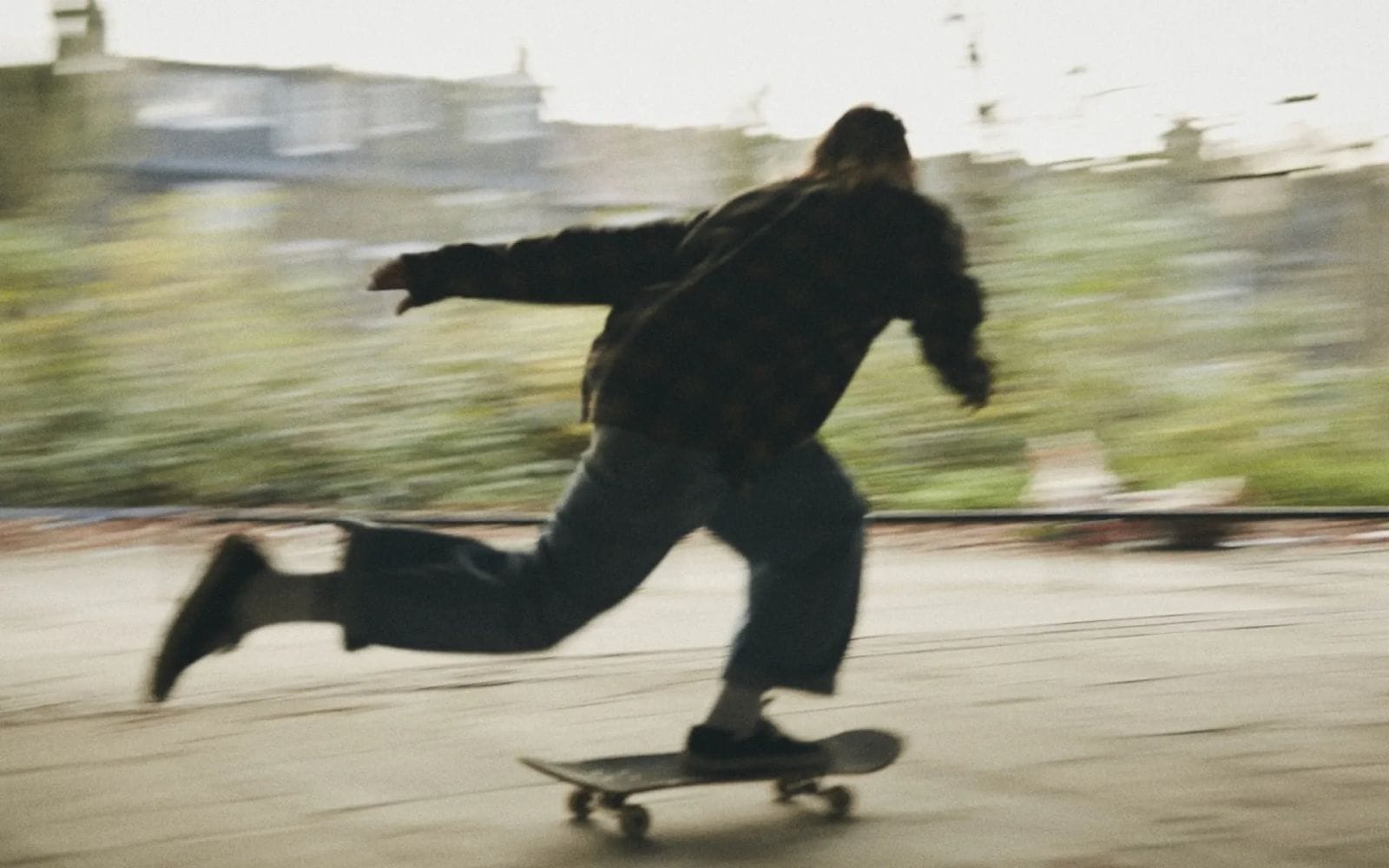 A person skateboarding down the street