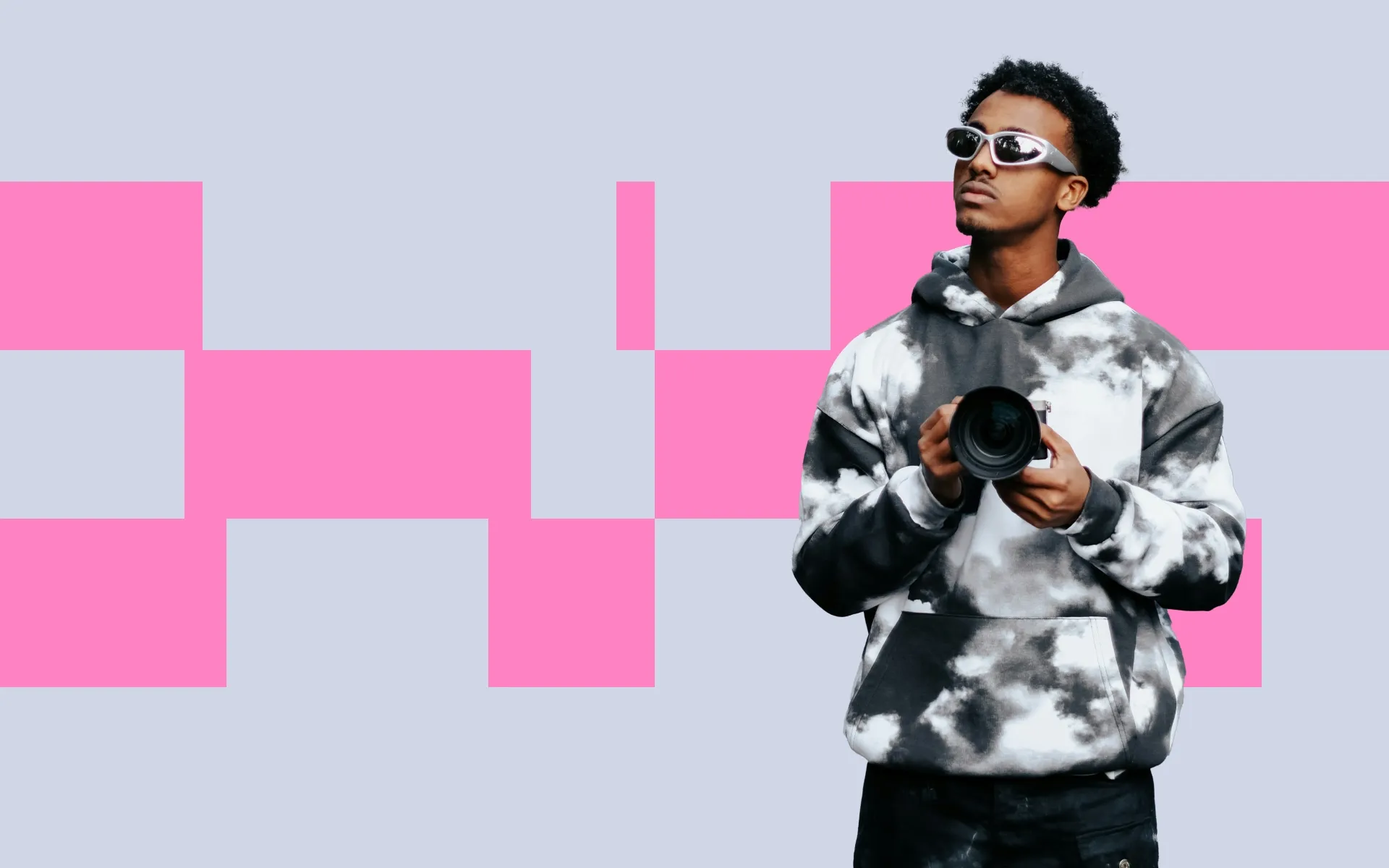 A man wearing sunglasses and holding a camera