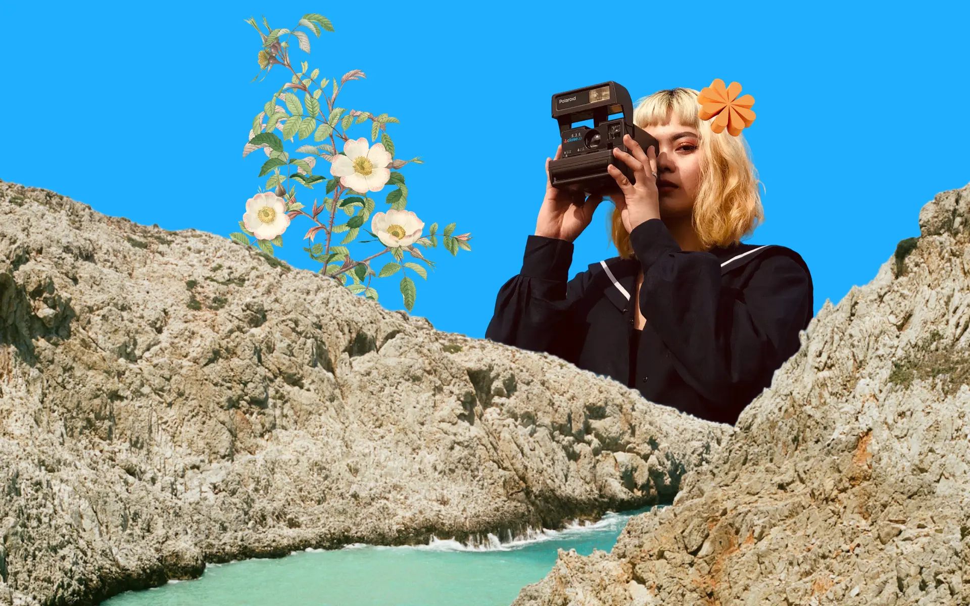 A person taking photos over a cliff, with some water running between the two cliffs