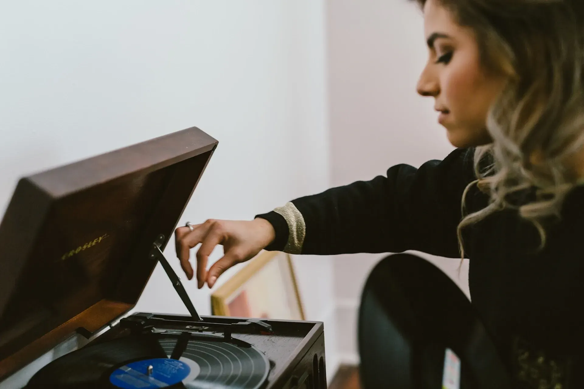 A woman playing a vinyl record