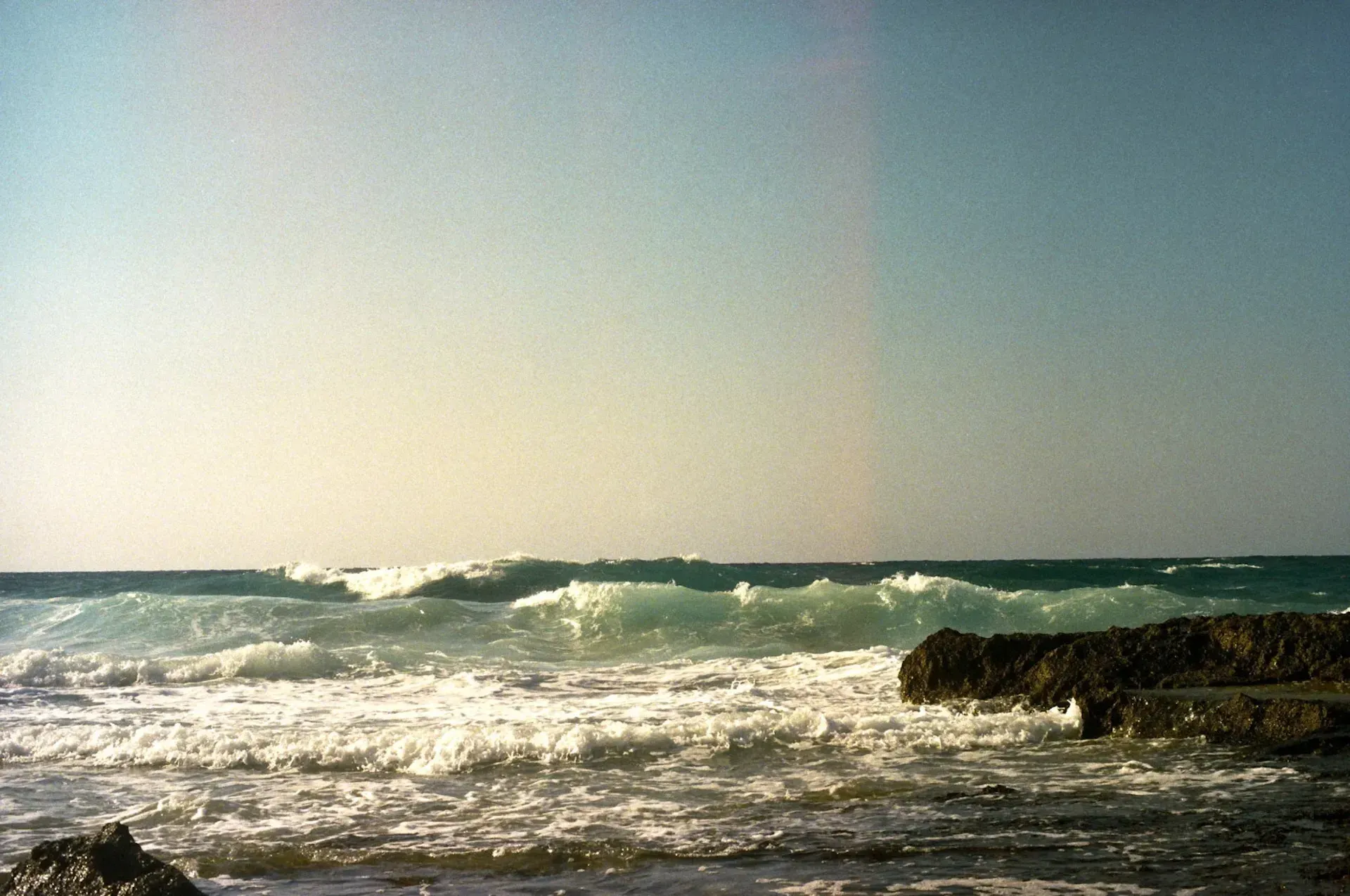 Waves crashing away from the shore.