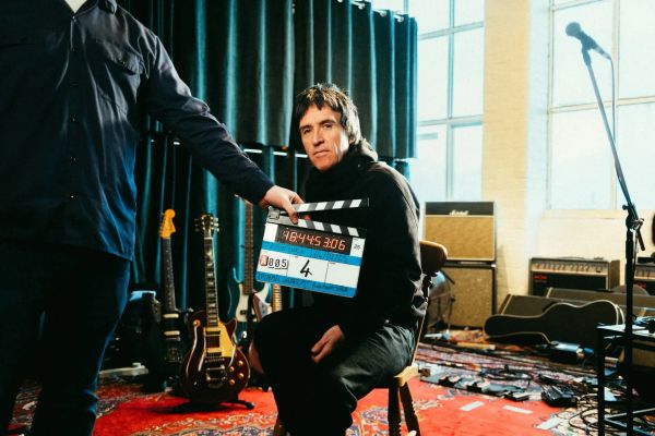 Johnny Marr behind a clapper board 