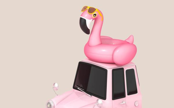 An inflatable flamingo on top of a pink car