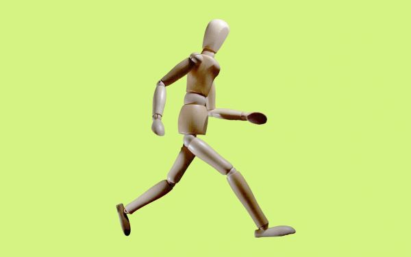 Wooden mannequin running