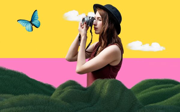 A woman taking a photo of a butterfly
