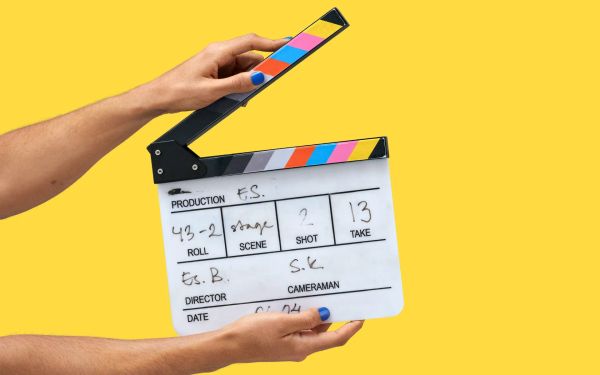 Hands holding a clapper board open