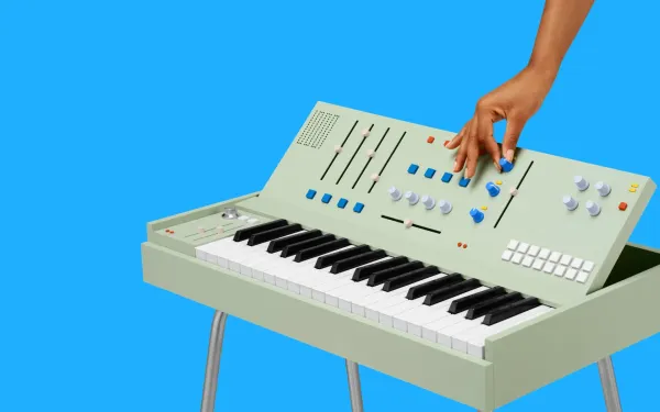 A hand playing a strange, keyboard-type device
