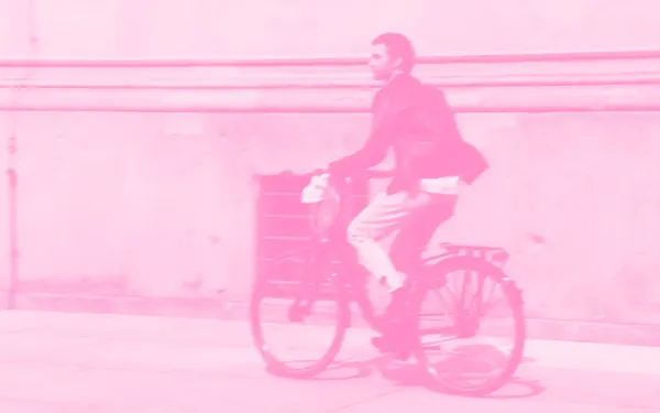A man riding a bicycle down the street