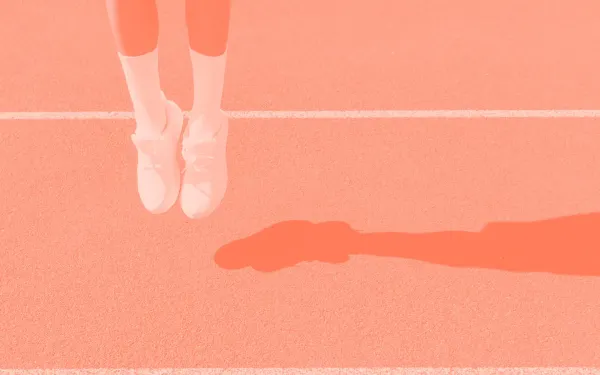 A person’s legs jumping from a racetrack