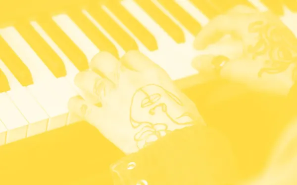Tattooed hands playing piano