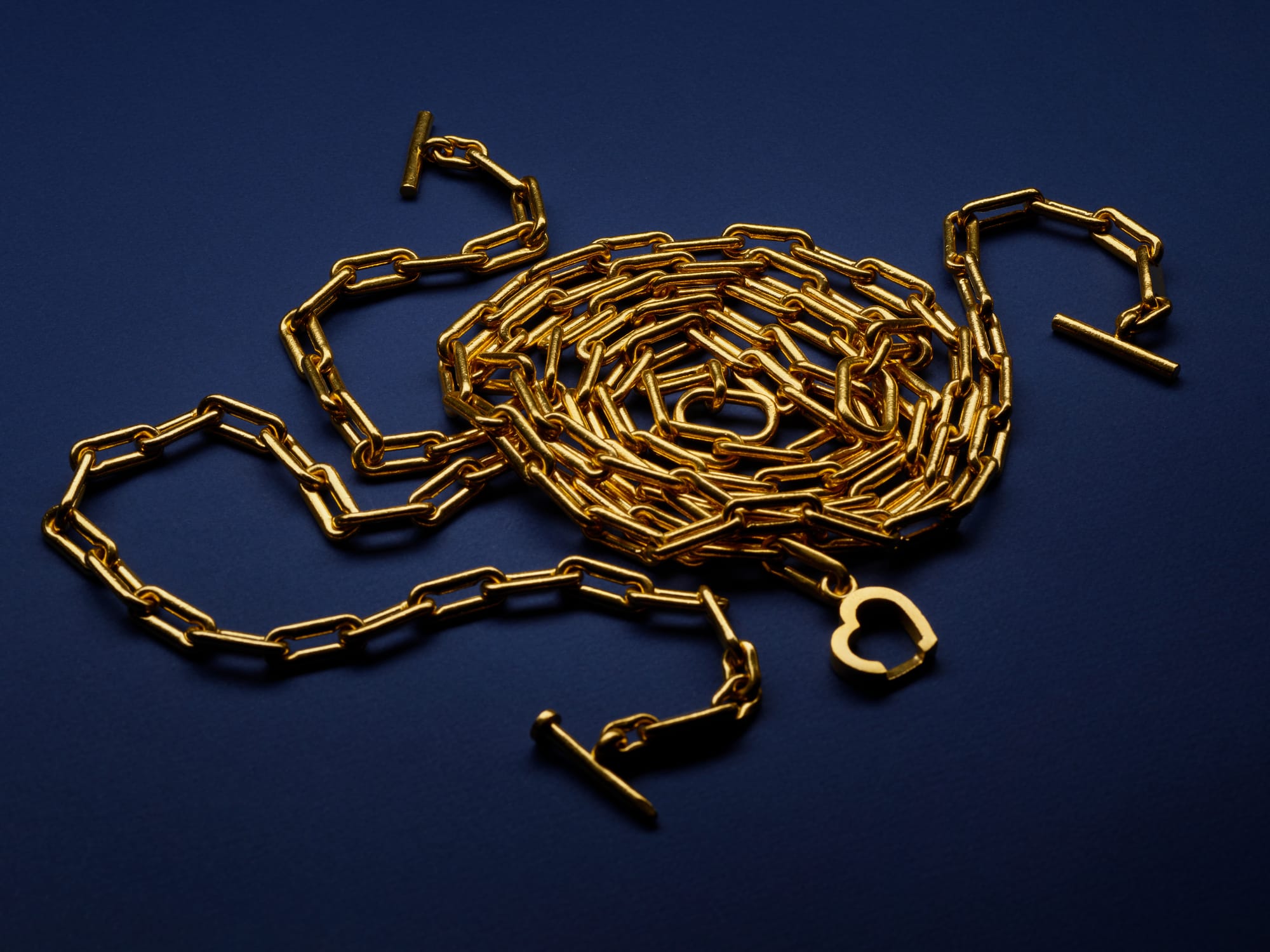 Menē 24k gold Linear Link and Heart and Nail Chains.