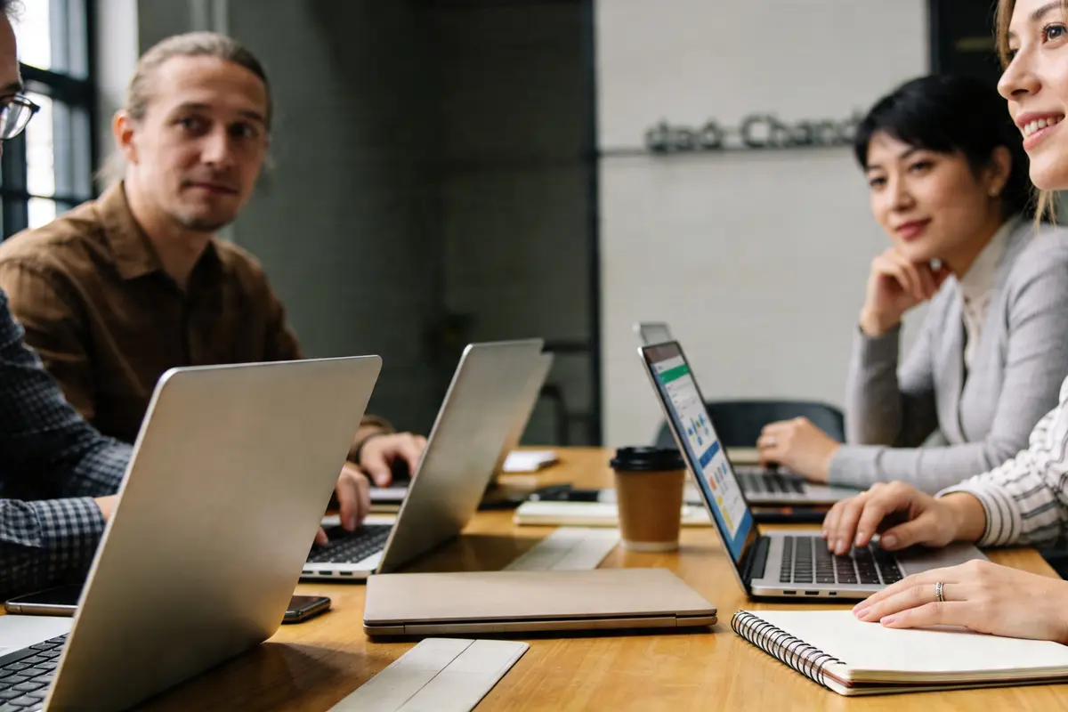 Agency account manager presenting chatbot performance insights to a client in a warm meeting room, no visible screen text, natural daylight