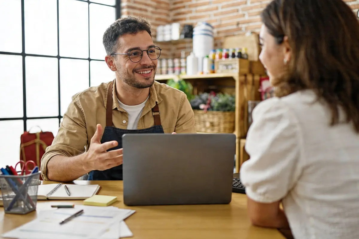 Small business owner reviewing chatbot enquiries in a bright modern office