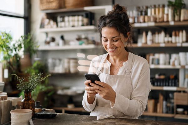 Small business owner capturing a lead on her phone