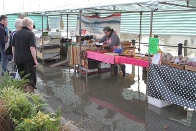 Shoppers retreat from the rising tide while the French Delicatessen deploys a ramp to stay dry
