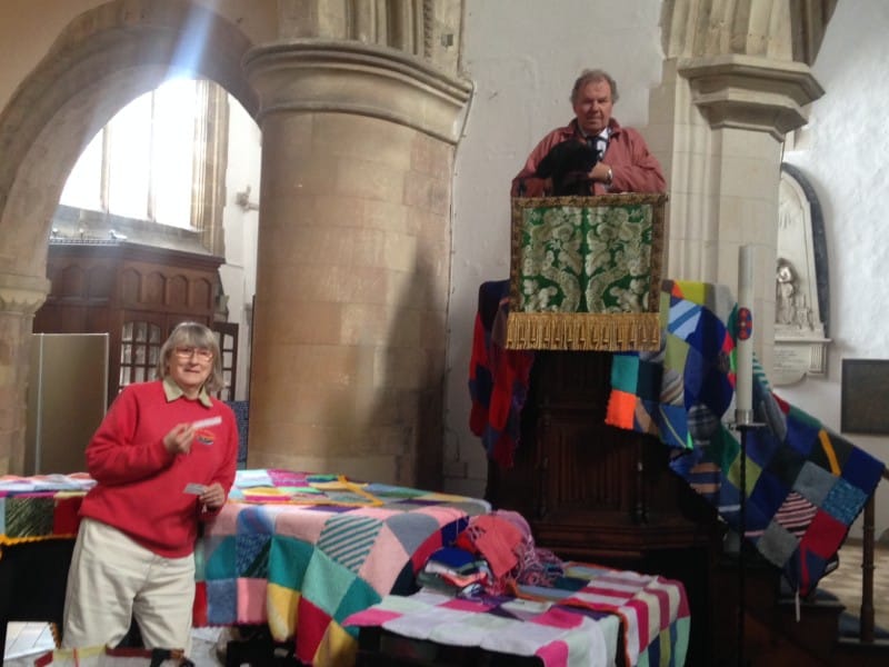 Verger Tony Dagleas and church cat Sylvester Frost survey the finished blankets from the pulpit. Sandra Lanigan is below left