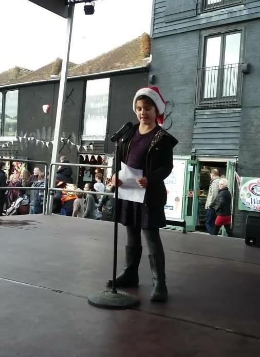 Kayla Crouch reading her award winning poem out on the main stage