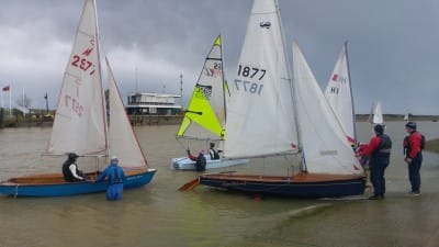 Crew stand waist-deep in icy water as the boats are launched