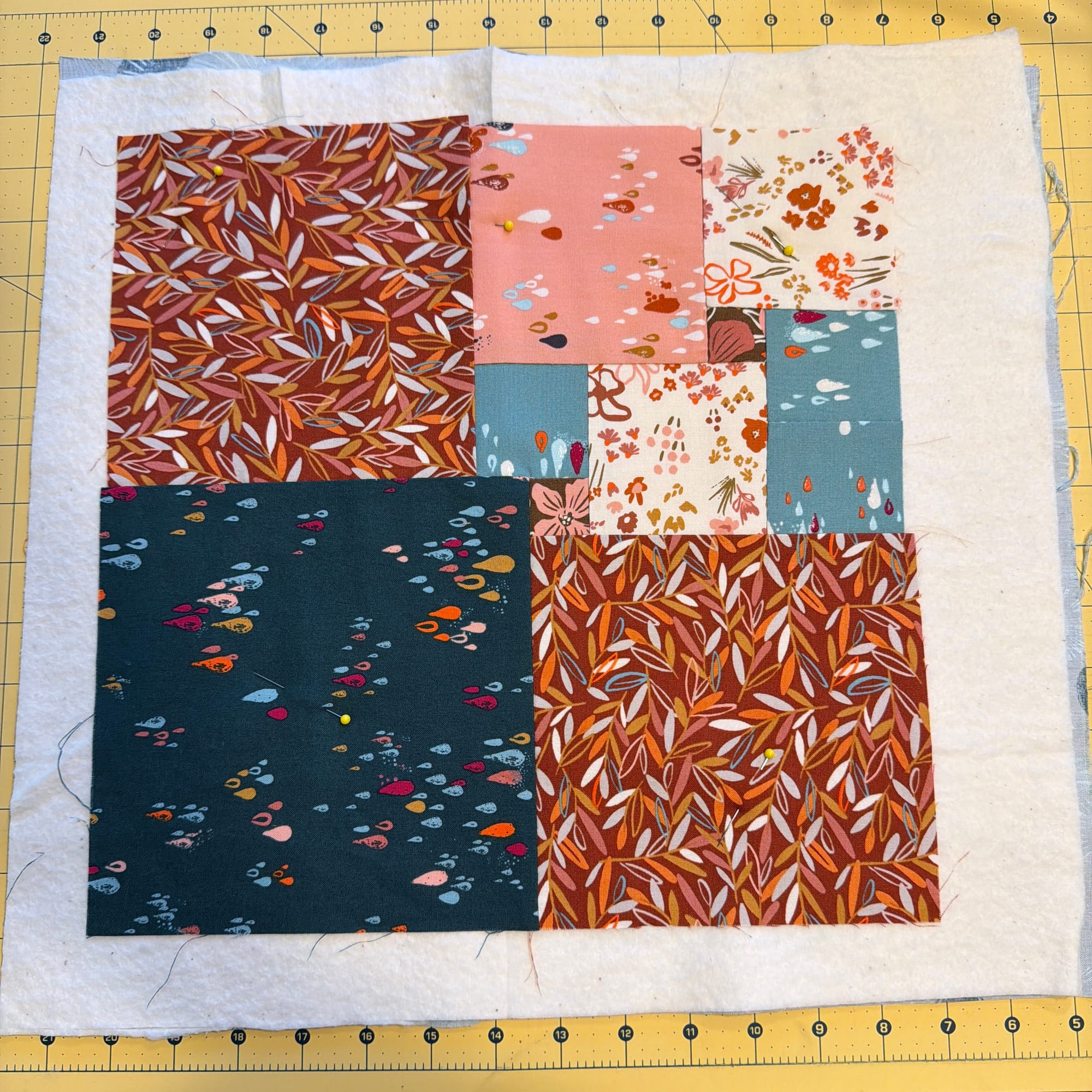 quilt top on batting on a cutting mat