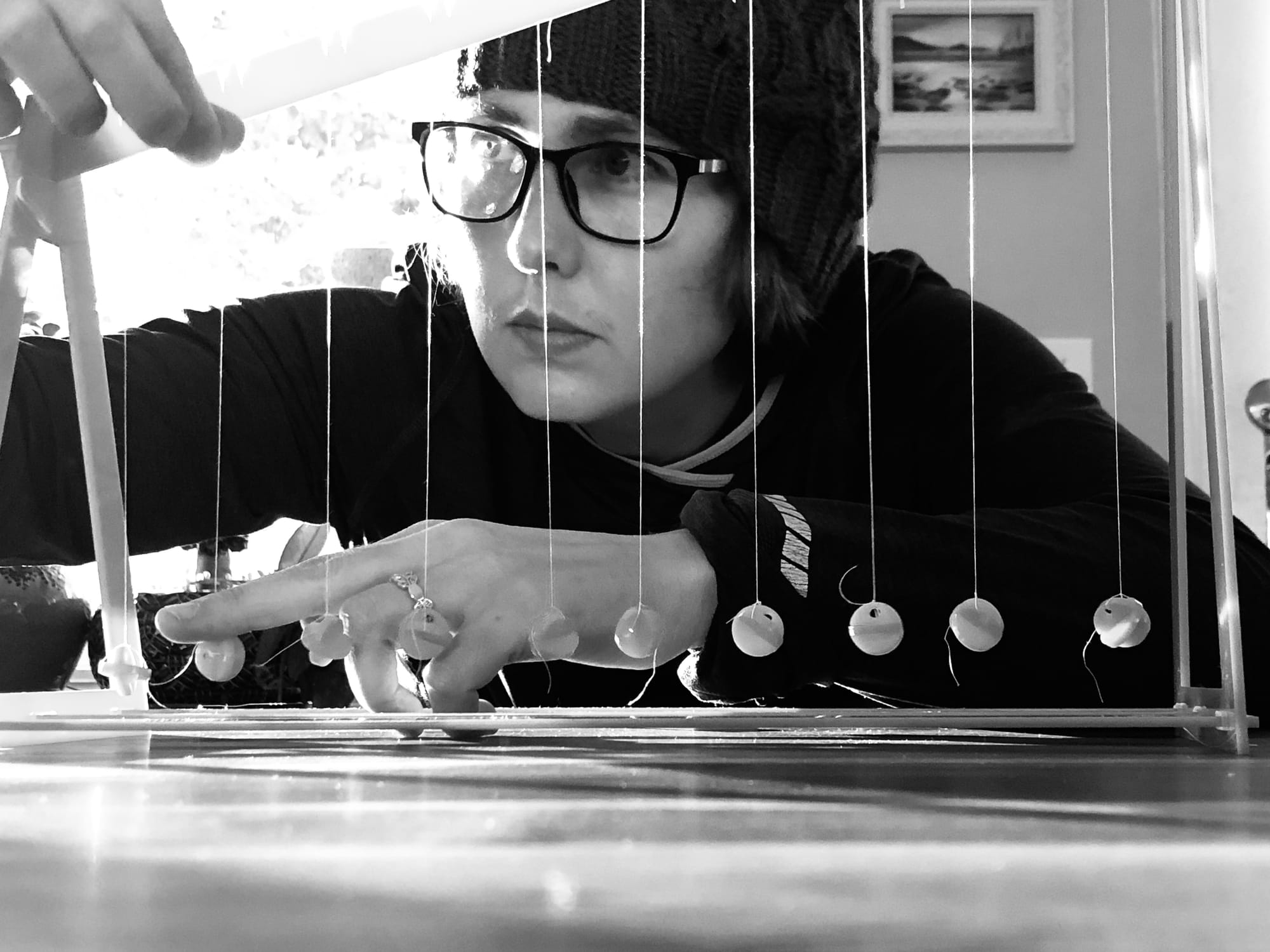 a woman (me) with a laser cut wave pendulum