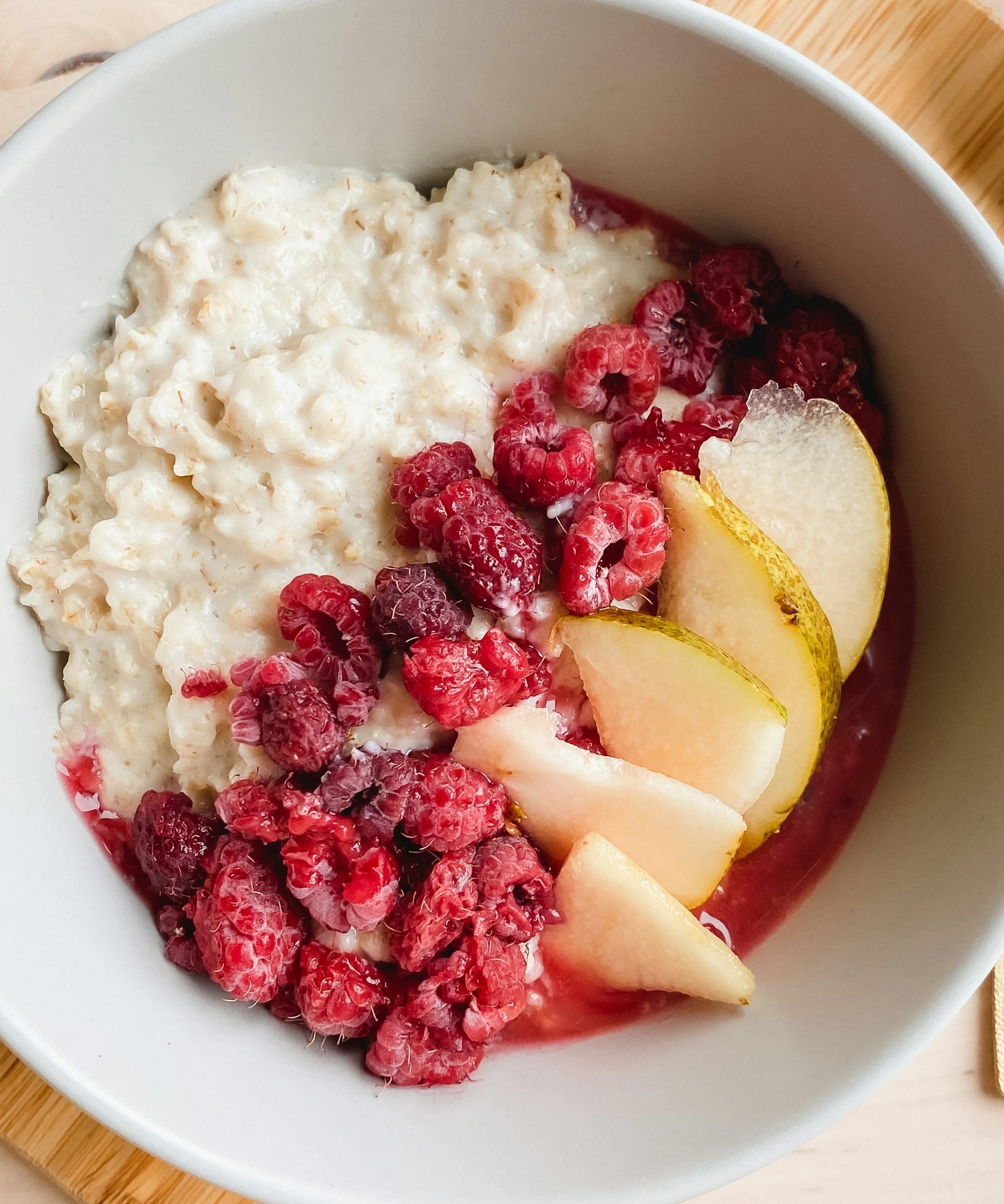 sliced apples and bananas in white ceramic bowl