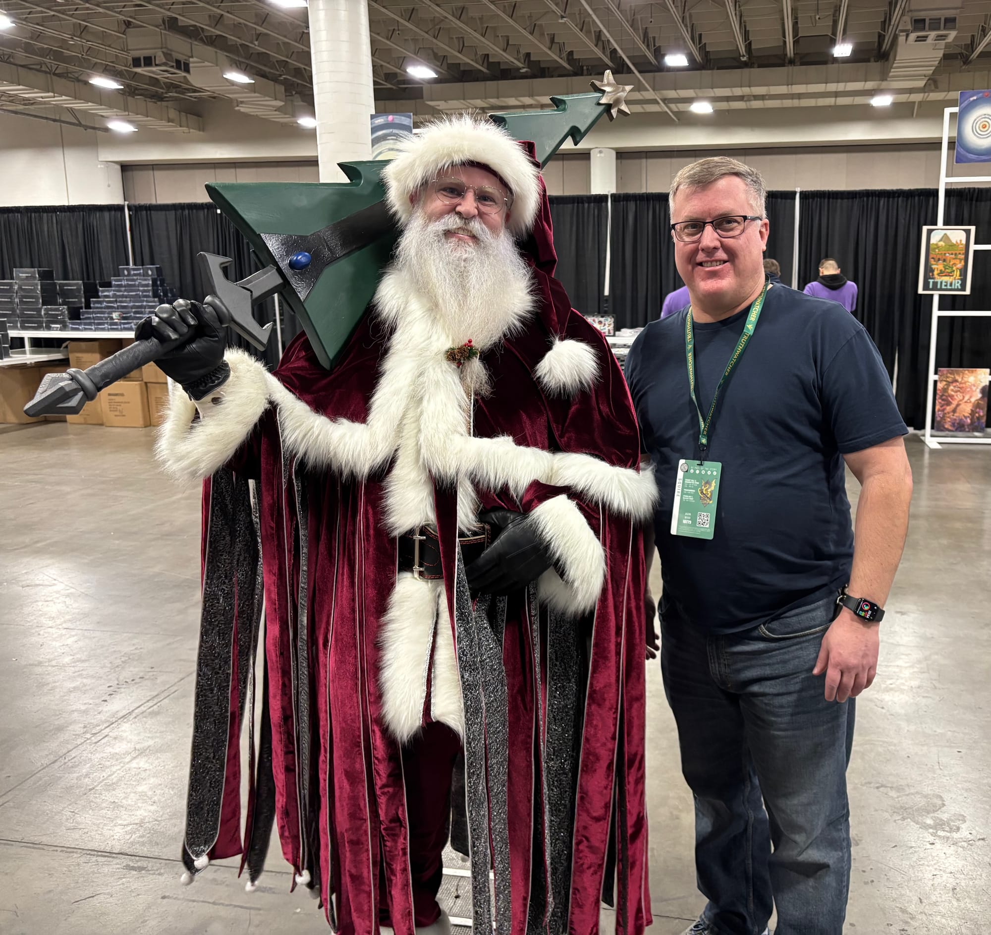 Jason Wood standing with the Mistborn Santa at Dragonsteel Nexus 2024