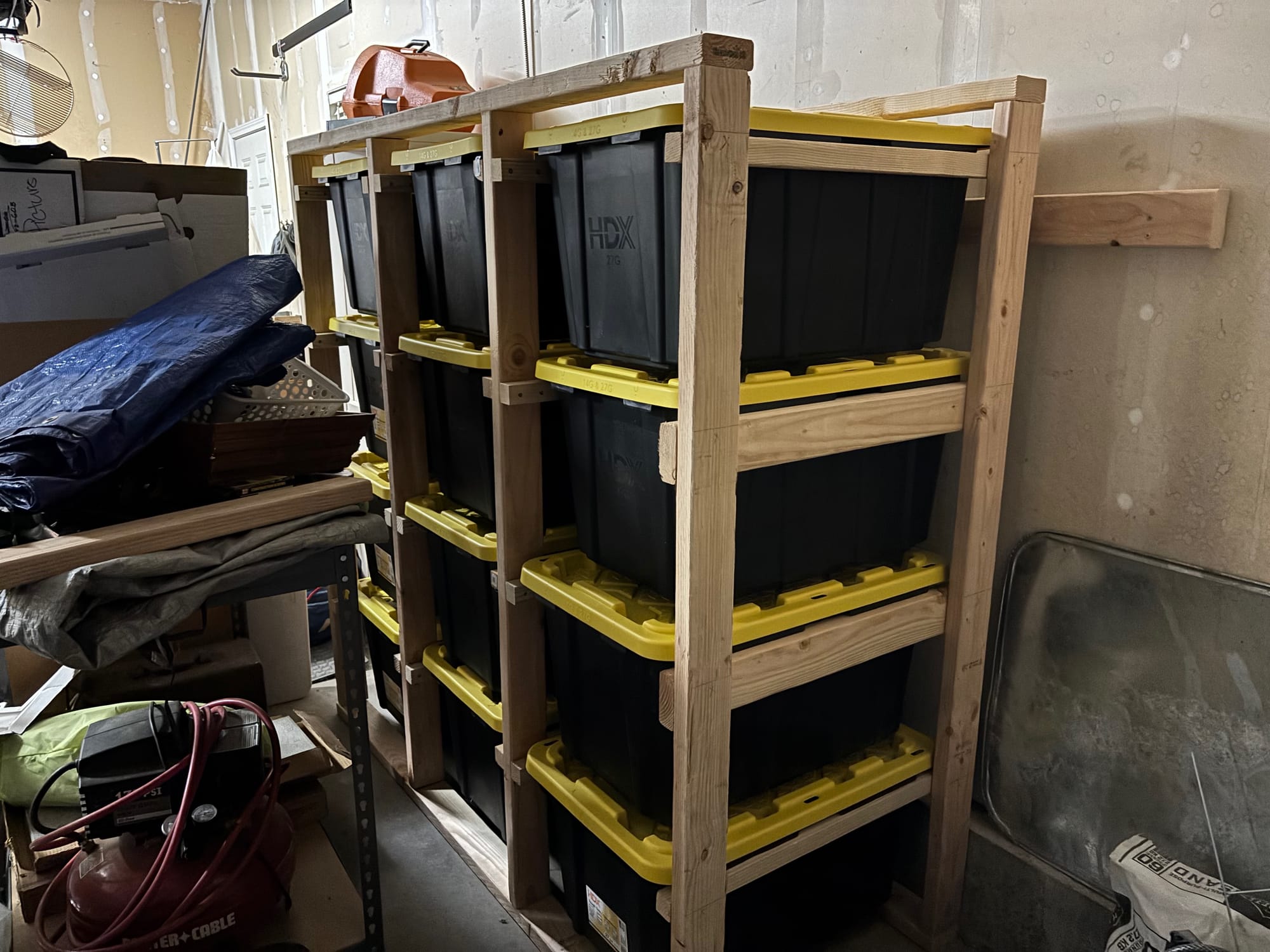 storage totes in wood storage rack in the garage