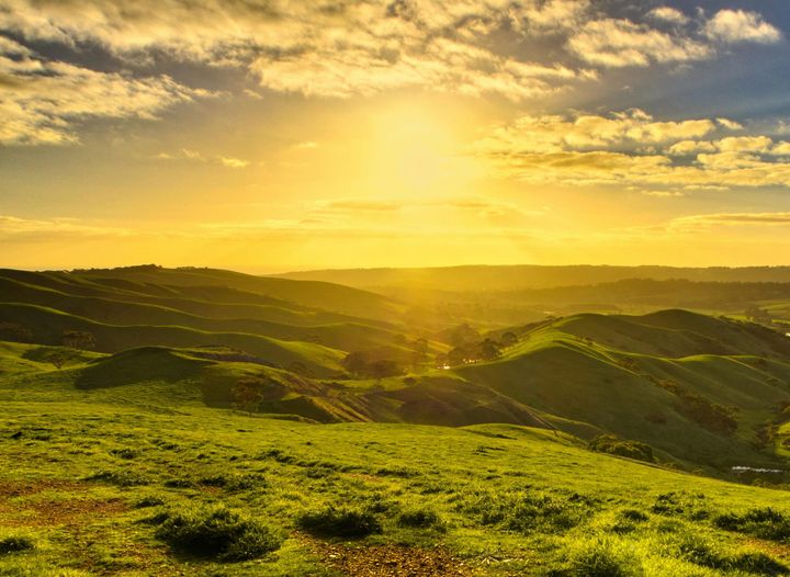 Sunrise over green hills and valleys