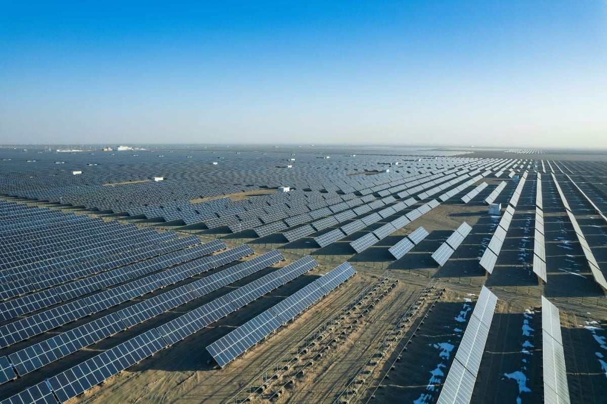 A vast solar power plant with panels stretching to the horizon