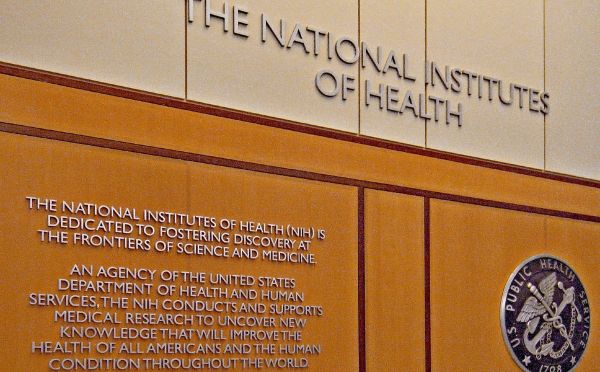 The wall in the lobby at the National Institutes of Health, where it says the NIH is "dedicated to fostering discovery at the frontiers of science and medicine."