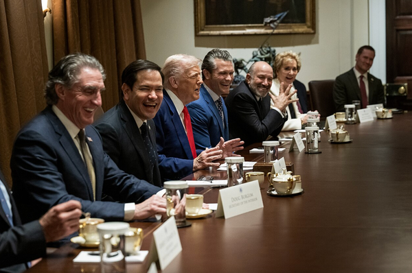 Doug Burgum, Marco Rubio, Donald Trump, Pete Hegseth, Howard Lutnick, and others around a conference table, laughing like jackasses