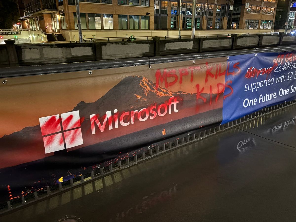 A photograph of a Microsoft ad that's been spray painted over. The grafitti says "MSFT KILLS KIDS".