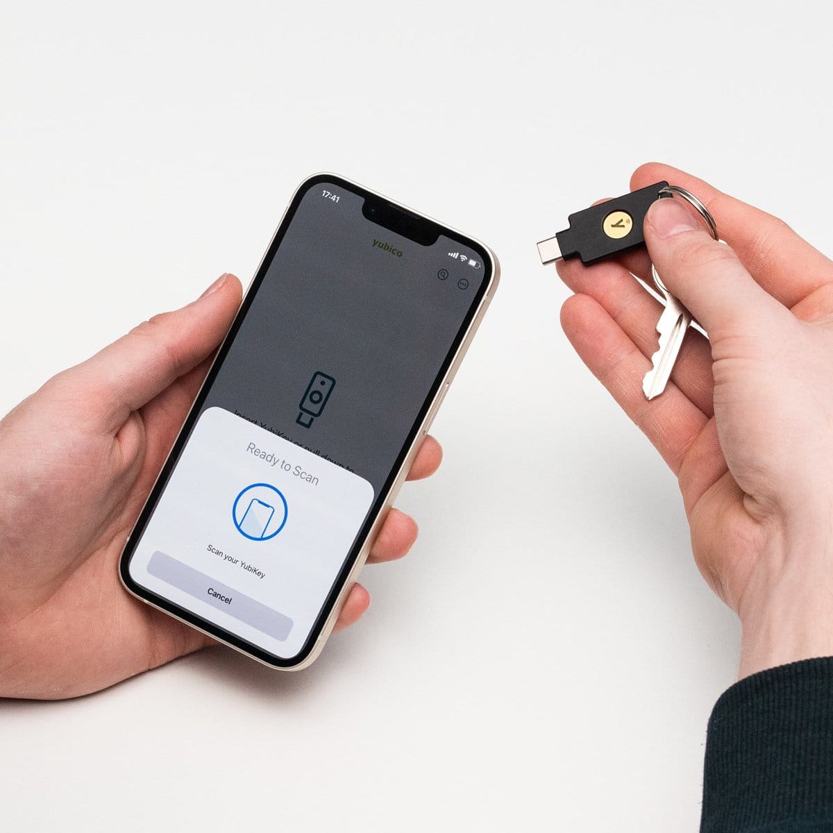 A Yubico security key being tapped against the back of a phone to sign in