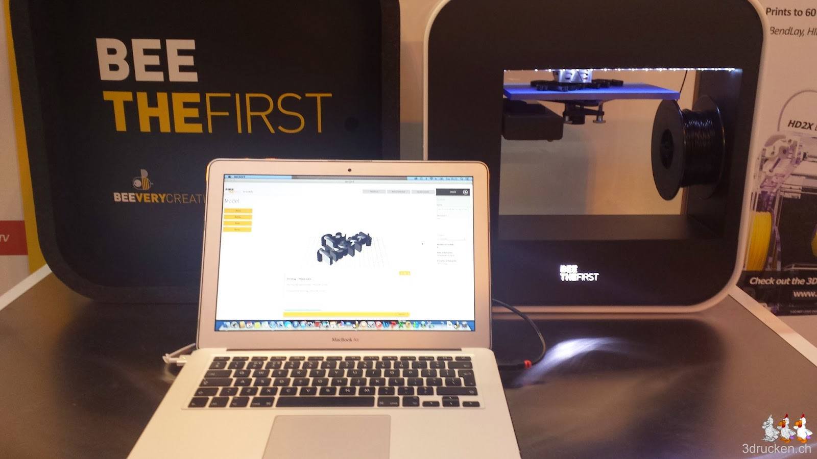 Foto eines BEETHEFIRST 3D-Druckers und einem Macbook mit der passenden Software drauf