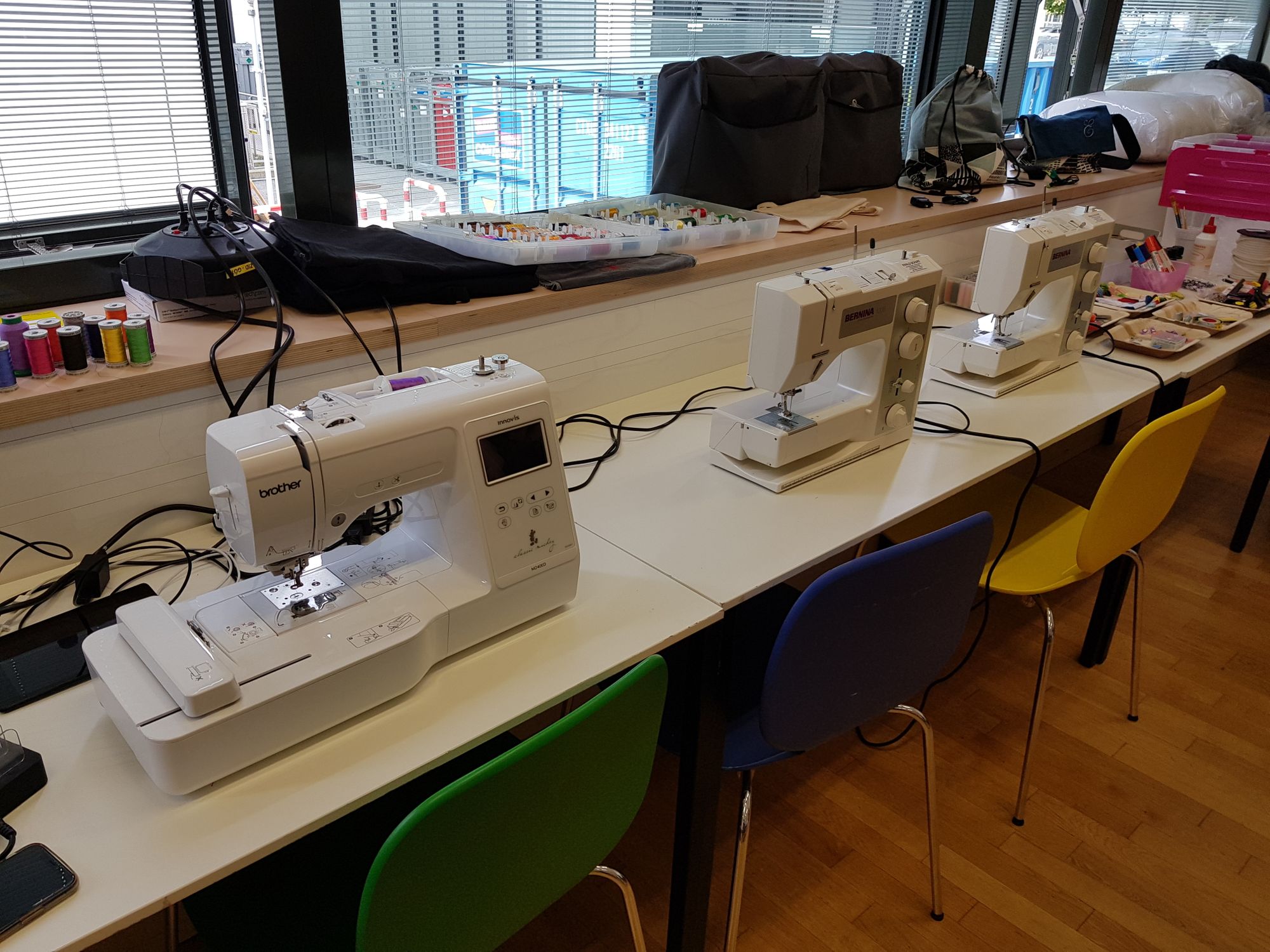 Brother Stickmaschine und zwei Bernina Nähmaschinen auf Tischen. 