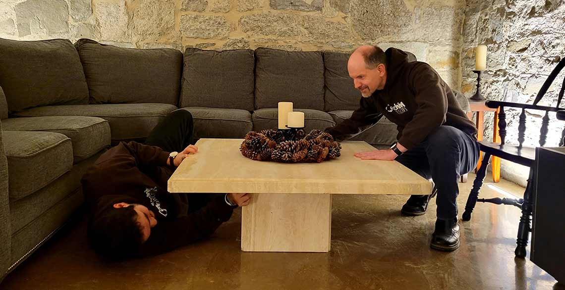 Postulants Leo (L) and Peter (R) move furniture into the lower level of the newly-renovated St. Francis of Assisi Monasery.