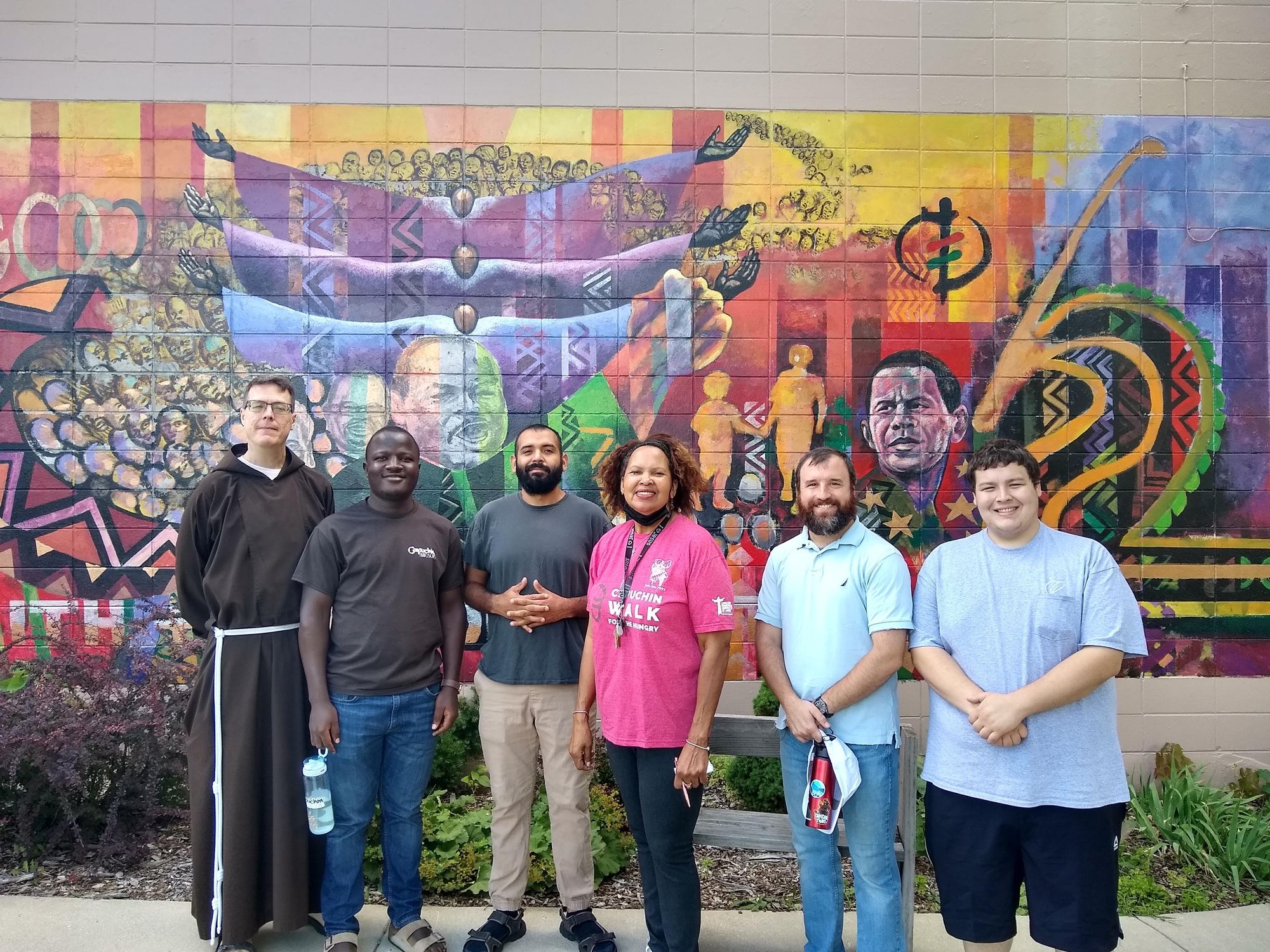 Capuchin postulants with Br. David Hirt and Linda Barnes, Assistant Director of Capuchin Community Services outside the House of Peace in Milwaukee.