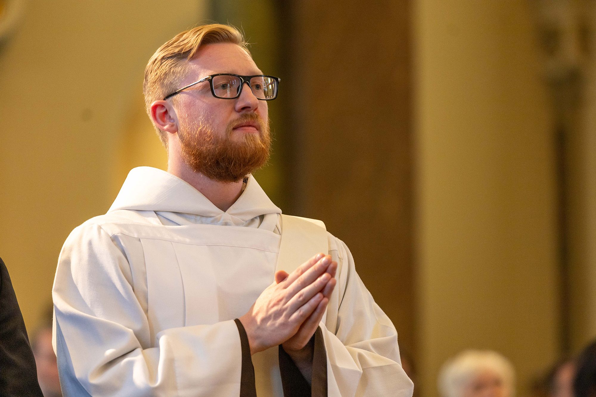 Color interior photograph of Br. Nathan Linton, OFM Cap. at his ordination.